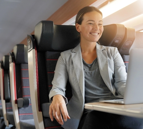 Partner working on a laptop while traveling